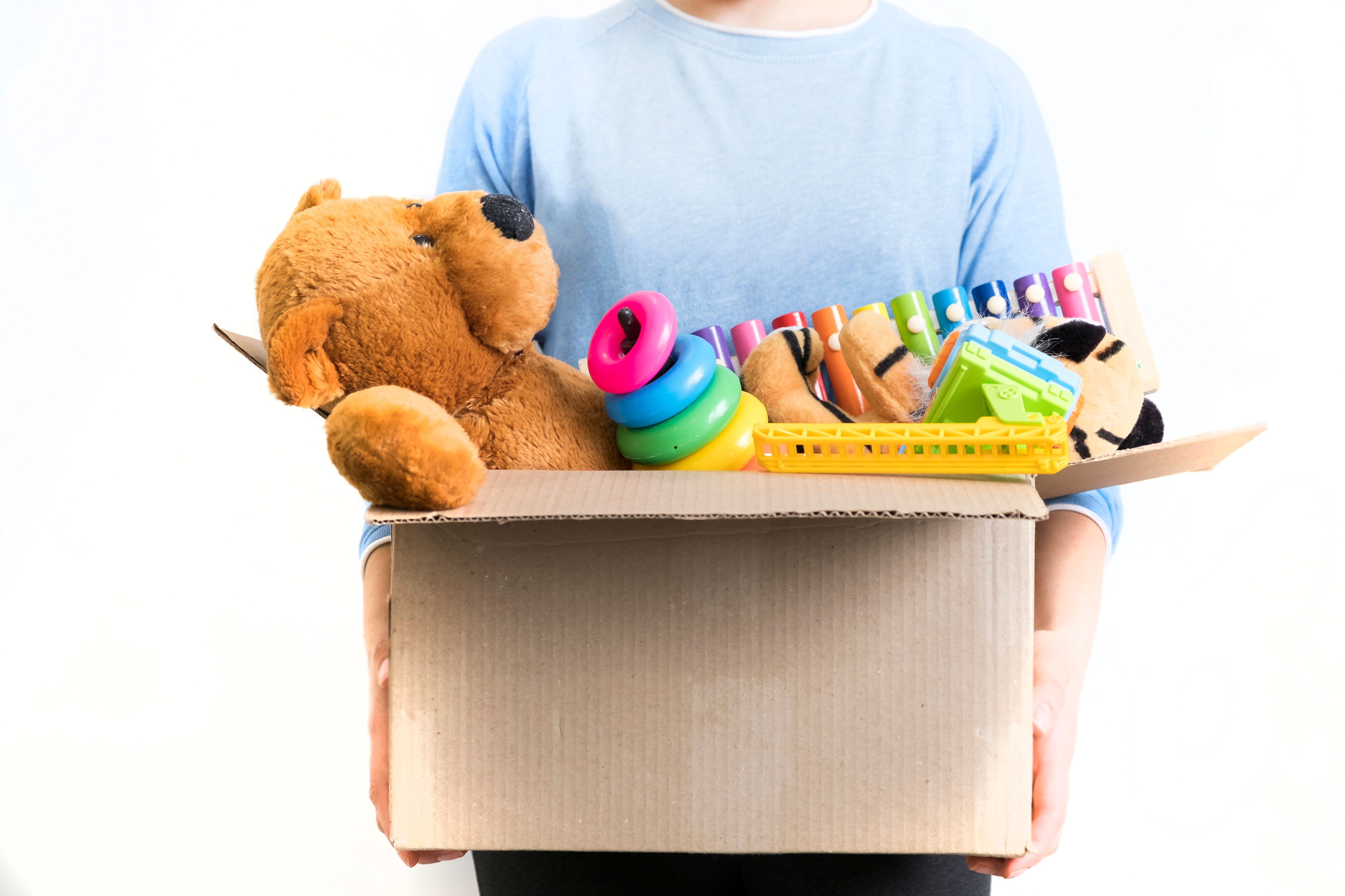 male-volunteer-holding-donation-box-with-toys.jpg